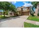 Charming two-story home with a well-maintained lawn, mature trees and a paved driveway at 7029 Dowling Mill Cir, Tampa, FL 33625