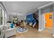 Open-concept living room featuring staircase and blue accent wall art at 7029 Dowling Mill Cir, Tampa, FL 33625