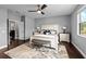 Main bedroom with dark wood floors, a ceiling fan, a rug, and a queen-size bed at 7029 Dowling Mill Cir, Tampa, FL 33625