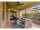 Covered patio featuring comfortable seating and an outdoor ceiling fan at 7029 Dowling Mill Cir, Tampa, FL 33625