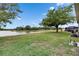 Expansive backyard with lush lawn and tranquil water views, perfect for outdoor gatherings at 7511 Turtle View Dr, Ruskin, FL 33573