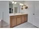 Bathroom featuring double sinks, decorative tile flooring, a large mirror and stylish lighting at 7511 Turtle View Dr, Ruskin, FL 33573