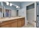 Bright bathroom showcasing a double-sink vanity, large mirror, and a doorway to the toilet and shower area at 7511 Turtle View Dr, Ruskin, FL 33573