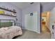 Bright, purple bedroom showcasing shelves, decor, closet and a doorway into the Primary bathroom at 7511 Turtle View Dr, Ruskin, FL 33573