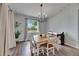 Inviting dining room with bright light, modern chandelier, and stylish wood floors at 7511 Turtle View Dr, Ruskin, FL 33573