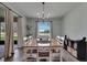 Inviting dining room with sliding door, natural light, modern chandelier, and stylish wood floors at 7511 Turtle View Dr, Ruskin, FL 33573