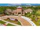Exterior of a community center building featuring stone accents, shade structures, and an inviting brick paved entrance at 7511 Turtle View Dr, Ruskin, FL 33573