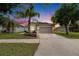 Charming single Gathering home with a well-manicured lawn and mature landscaping at sunset at 7511 Turtle View Dr, Ruskin, FL 33573