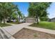 Desirable property featuring a manicured lawn, mature trees, and a long driveway leading to the attached garage at 7511 Turtle View Dr, Ruskin, FL 33573
