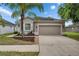 Lovely single-Gathering home with a well-maintained lawn, fresh mulch landscaping, and an attached garage at 7511 Turtle View Dr, Ruskin, FL 33573