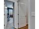 Hallway with wood-look floors leads to a bedroom with a study area, creating a welcoming transition at 7511 Turtle View Dr, Ruskin, FL 33573