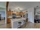 Open kitchen featuring a large island, stainless steel appliances, and wood-look tile flooring at 7511 Turtle View Dr, Ruskin, FL 33573