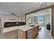 Open kitchen with island sink, living room and dining room at 7511 Turtle View Dr, Ruskin, FL 33573
