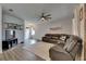 Bright living room featuring wood floors, a large leather sofa and front door access at 7511 Turtle View Dr, Ruskin, FL 33573