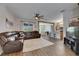 Open concept living room featuring wood floors, a large leather sofa and seamless flow into the kitchen and dining areas at 7511 Turtle View Dr, Ruskin, FL 33573