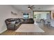 Bright living room featuring wood floors, large leather sofa and seamless flow into the kitchen and dining areas at 7511 Turtle View Dr, Ruskin, FL 33573