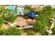 Playground featuring swings, slides, and climbing equipment under a shade structure, surrounded by trees at 7511 Turtle View Dr, Ruskin, FL 33573