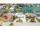 A sunny aerial view shows waterfront homes with boat docks and well-manicured lawns in a desirable coastal neighborhood at 7889 3Rd S Ave, St Petersburg, FL 33707