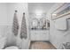 Tasteful bathroom featuring a double vanity, marble accents, and a walk-in shower with glass door at 7889 3Rd S Ave, St Petersburg, FL 33707