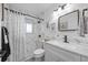 Bright bathroom featuring marble tile, a shower, and a modern vanity with black hardware at 7889 3Rd S Ave, St Petersburg, FL 33707
