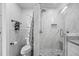 Sleek bathroom showcasing a frameless glass shower with marble tiling and a built-in niche at 7889 3Rd S Ave, St Petersburg, FL 33707