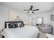 Relaxing bedroom with a plush bed, stylish throw pillows, ceiling fan, and ample natural light at 7889 3Rd S Ave, St Petersburg, FL 33707