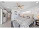 Bright bedroom featuring a ceiling fan, and a comfortable bed with stylish bedding and a bench at 7889 3Rd S Ave, St Petersburg, FL 33707