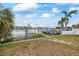 A private boat dock with a motorboat and clear views of the surrounding waterfront community at 7889 3Rd S Ave, St Petersburg, FL 33707