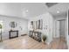 Inviting entryway with sleek console table, modern art, and wood-look tile flooring at 7889 3Rd S Ave, St Petersburg, FL 33707