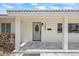 Charming front entrance featuring a tiled porch and an elegant oval-windowed door at 7889 3Rd S Ave, St Petersburg, FL 33707