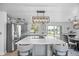 Open kitchen with stainless appliances, white counters, seating, and seamless access to dining at 7889 3Rd S Ave, St Petersburg, FL 33707