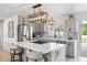 Modern kitchen with a large island, stainless steel appliances, and beautiful pendant lighting at 7889 3Rd S Ave, St Petersburg, FL 33707