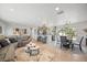 Open concept living and kitchen space with modern finishes, recessed lighting, and new plank flooring at 7889 3Rd S Ave, St Petersburg, FL 33707