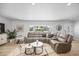 Bright living room featuring a comfortable sectional sofa, stylish decor, and large window view at 7889 3Rd S Ave, St Petersburg, FL 33707