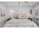 Bright main bedroom showcasing a neutral palette, plush bedding, and ample natural light at 7889 3Rd S Ave, St Petersburg, FL 33707