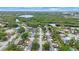 An aerial view shows the property's location near lush greenery and a serene lake at 8141 82Nd Ave, Seminole, FL 33777