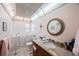 Bathroom featuring a walk-in tub, decorative mirror, vanity with granite countertops and a neutral color palette at 8141 82Nd Ave, Seminole, FL 33777