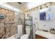 Updated bathroom features a glass enclosed shower, palm tree wallpaper, and modern fixtures at 8141 82Nd Ave, Seminole, FL 33777