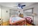 Bright bedroom featuring a bed, ceiling fan, hardwood floors, and natural light from the windows at 8141 82Nd Ave, Seminole, FL 33777