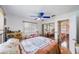 Bright bedroom features hardwood floors, a bed, closet with mirrored doors, and bright light from the windows at 8141 82Nd Ave, Seminole, FL 33777
