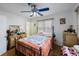 Bedroom features a bed, ceiling fan, hardwood floors, and bright natural light from multiple windows at 8141 82Nd Ave, Seminole, FL 33777