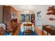 Bright dining room with a chandelier, hardwood floors, and a hutch near the entrance to the kitchen at 8141 82Nd Ave, Seminole, FL 33777