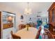 Bright dining room with a chandelier, hardwood floors, and open access to both the living room and kitchen at 8141 82Nd Ave, Seminole, FL 33777