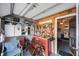 View of the garage with tools hung up on the wall and a workbench along with storage cabinets and equipment at 8141 82Nd Ave, Seminole, FL 33777