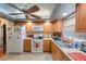 Charming kitchen features wood cabinets, modern appliances, tile flooring, and decorative ceiling at 8141 82Nd Ave, Seminole, FL 33777