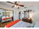 Bright bedroom features a bed, ceiling fan, dresser with mirror, and a closet with mirrored doors at 8141 82Nd Ave, Seminole, FL 33777