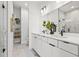 Elegant bathroom with a double vanity, modern fixtures, and a walk-in shower with marble tile at 883 6Th S Ave, St Petersburg, FL 33701