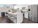 Modern kitchen featuring stainless steel appliances, a center island, and white cabinetry at 883 6Th S Ave, St Petersburg, FL 33701