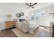Main bedroom featuring a ceiling fan, hardwood floors, and natural light at 883 6Th S Ave, St Petersburg, FL 33701