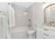 Modern bathroom with white marble tiled shower and vanity, and gold fixtures at 9481 Highland Oak Dr # 313, Tampa, FL 33647